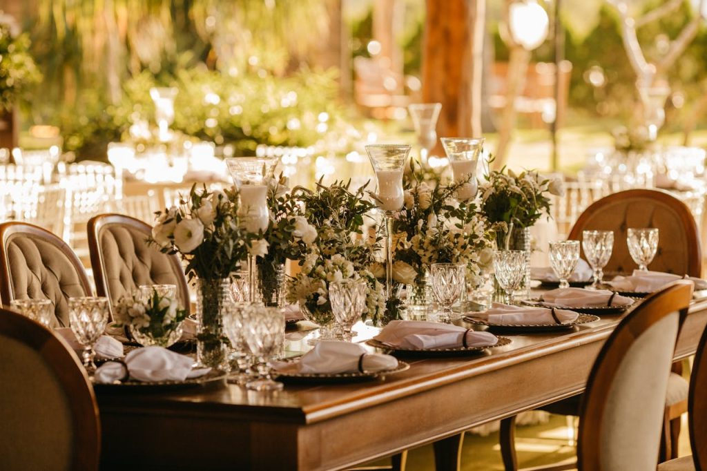 set-table-for-a-wedding-reception-12846017 Elegant outdoor wedding reception with beautifully set table, flowers, and glasses.